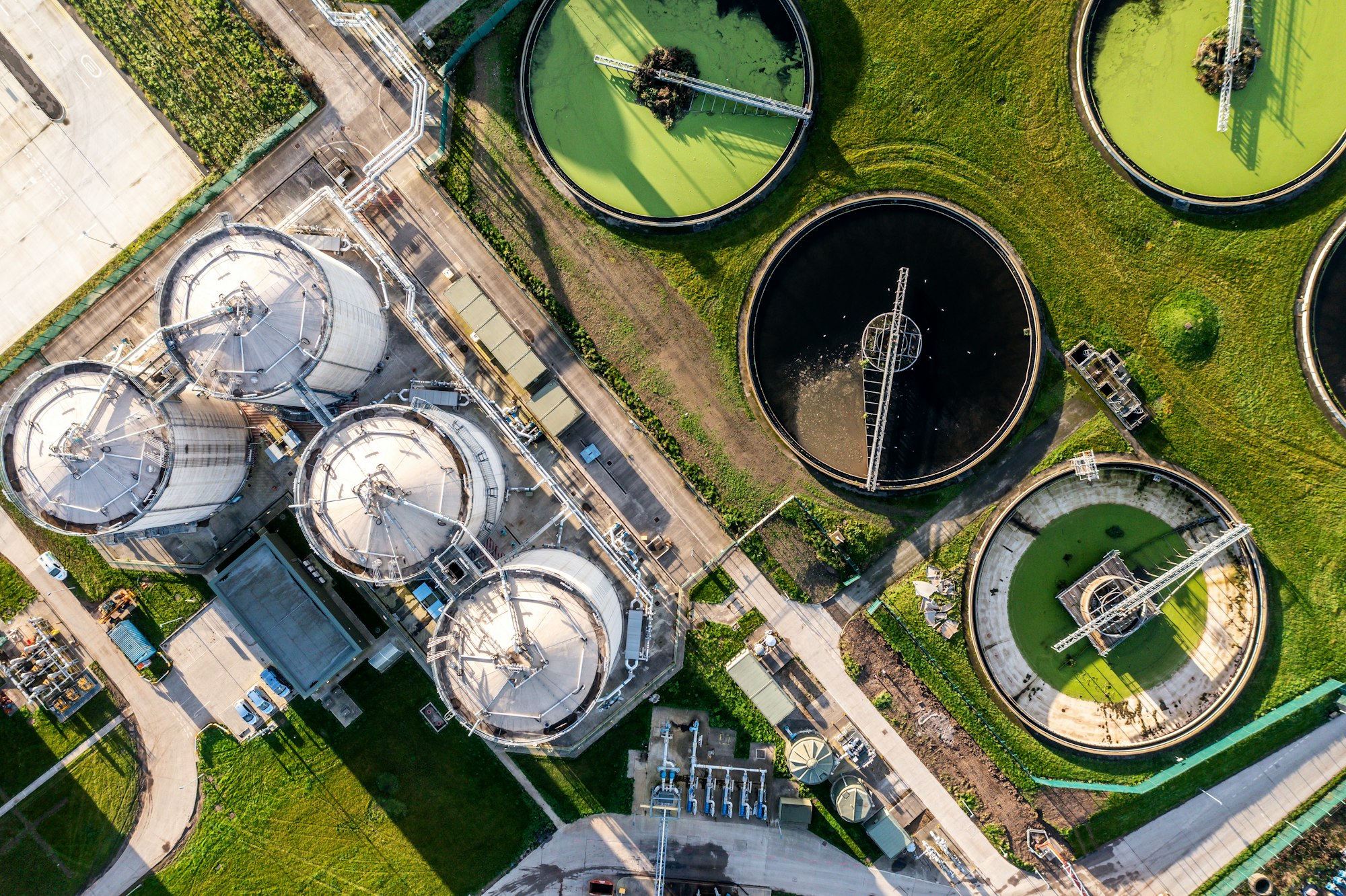 Aerial view above wastewater treatment plant with water storage tank