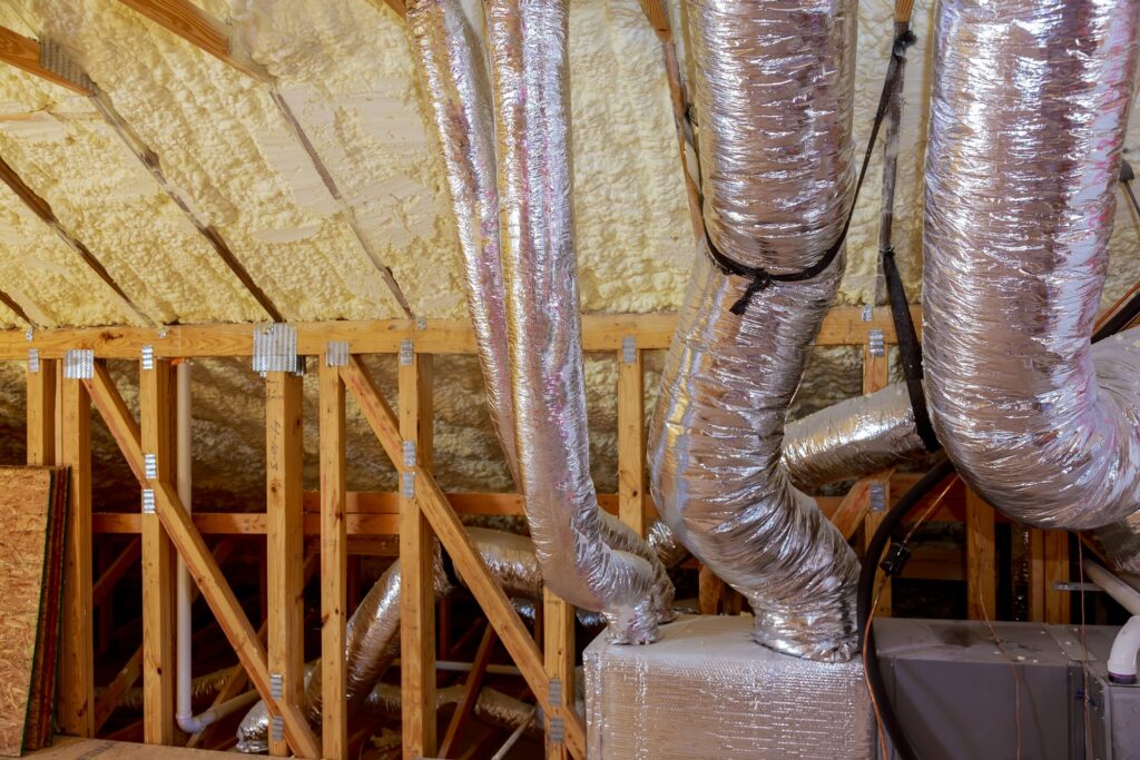 Framework showing the copper plumbing tubing and HVAC vents being installed