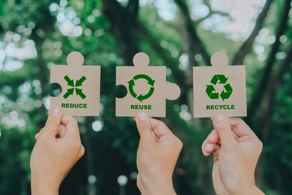 Hand holding Jigsaw with reduce, reuse, recycle symbol.Ecological waste management and a sustainable